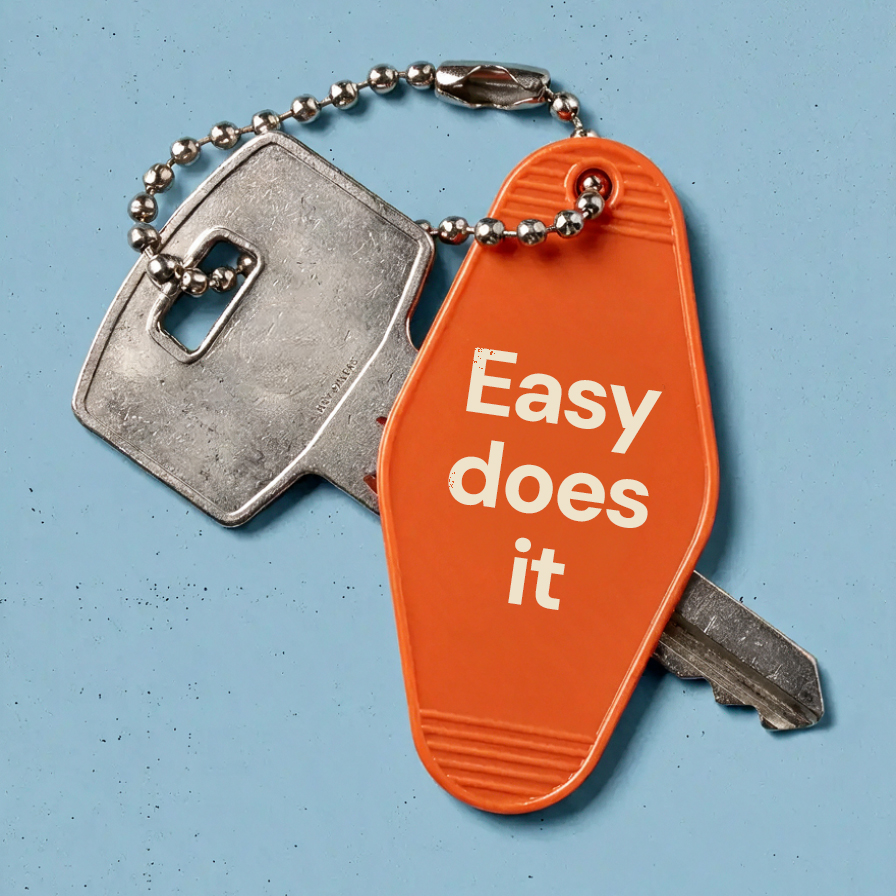 Orange keychain tag reading 'Easy does it' on a set of keys