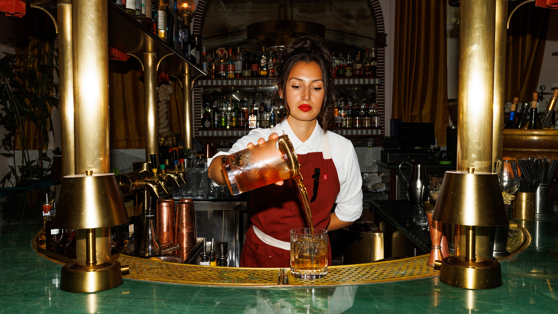 Bartender pouring a drink at a hotel bar