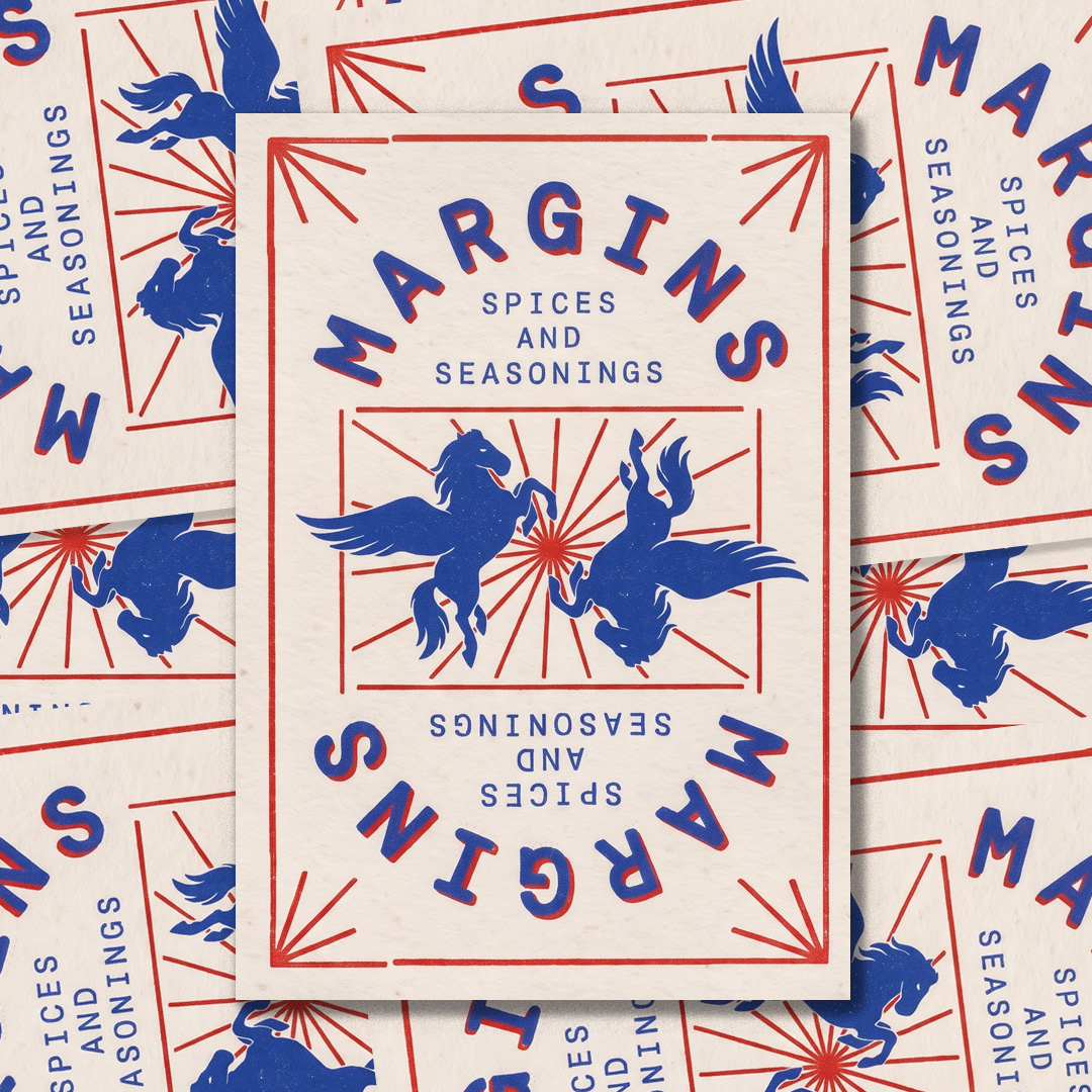 Pile of cream cards printed with mirrored Margins wordmarks and two blue winged horses around a red sunburst